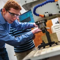 Engineering student engaged in project in lab.